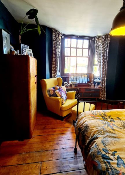 Picture of a dark blue and mustard decluttered and organised bedroom interior